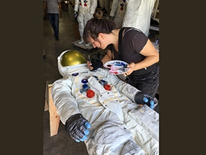Final painting being done on copy of Neil Armstrong's spacesuit